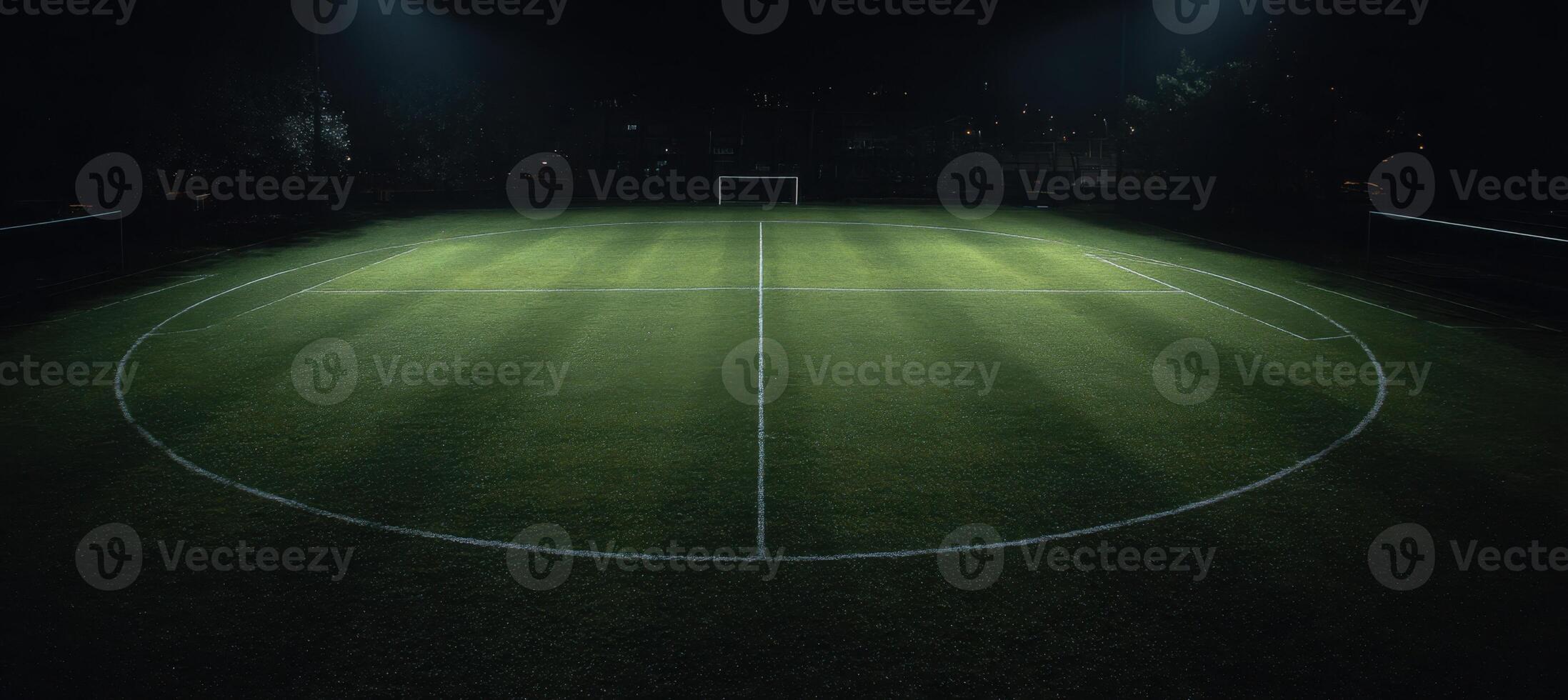 A soccer field at night with lights shining on it photo