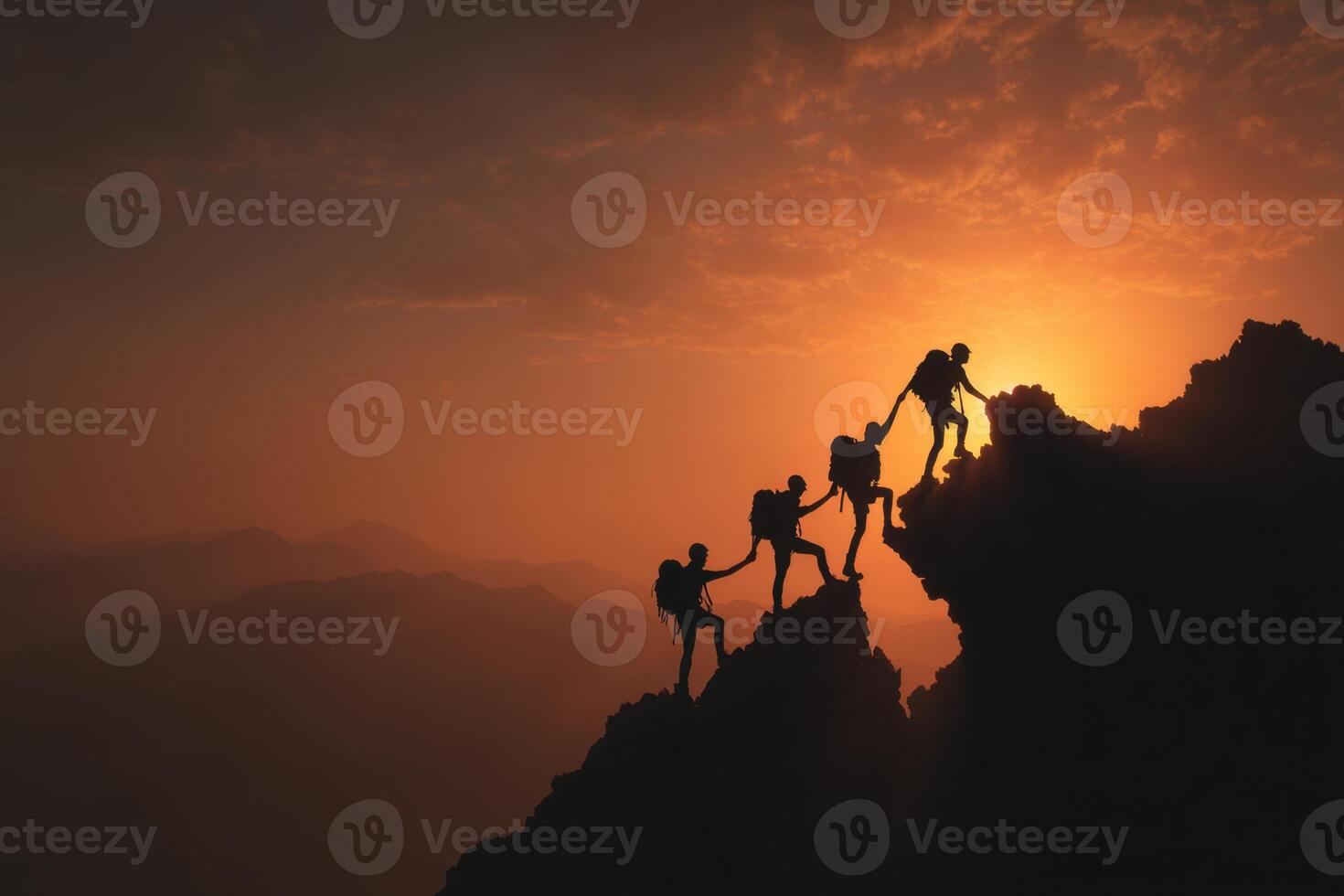 The Power of Teamwork Illustrates Four People Helping Each Other Climb to the Summit Against a Glowing Orange Sunset Sky While Creating a Sense of Unity photo