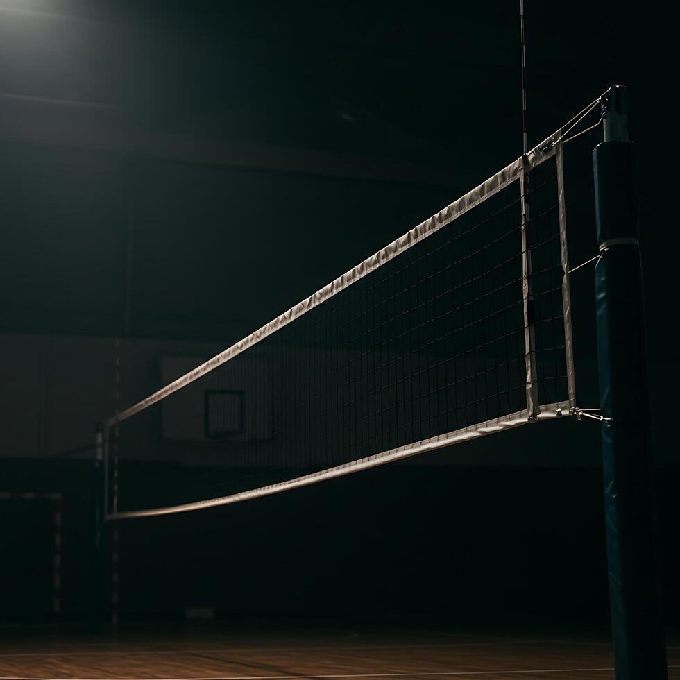 A volleyball net sits in the middle of a gym photo