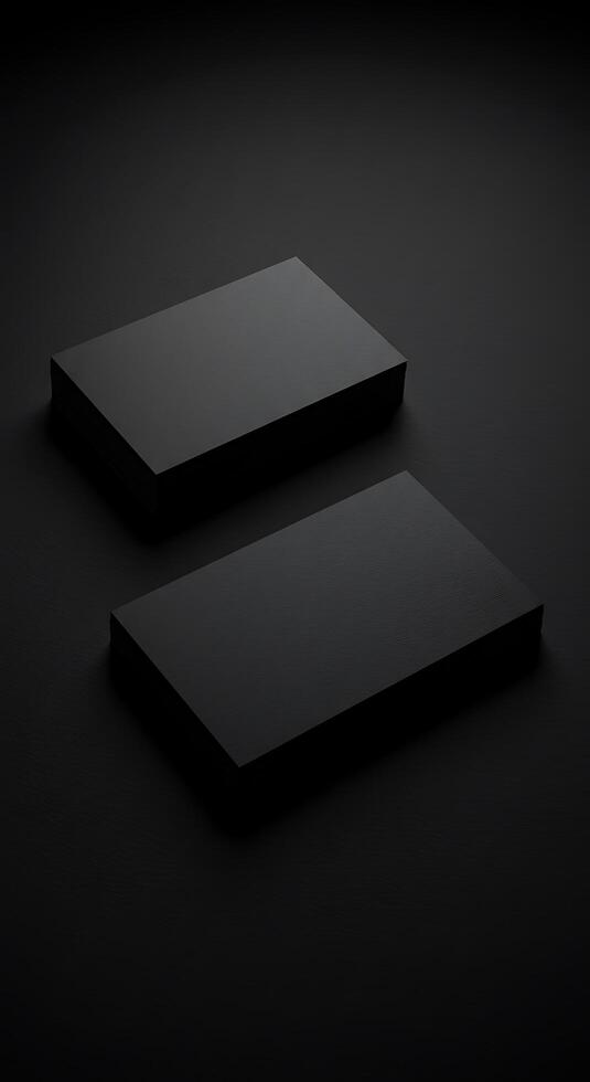 Two black boxes on a dark surface photo