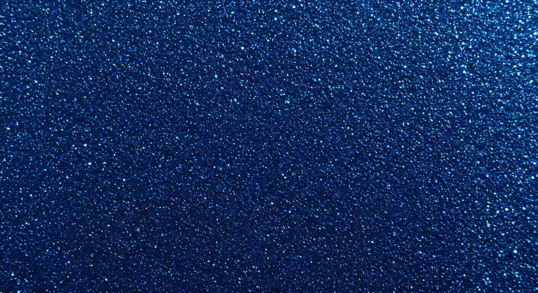 A blue background with a lot of small glitter photo