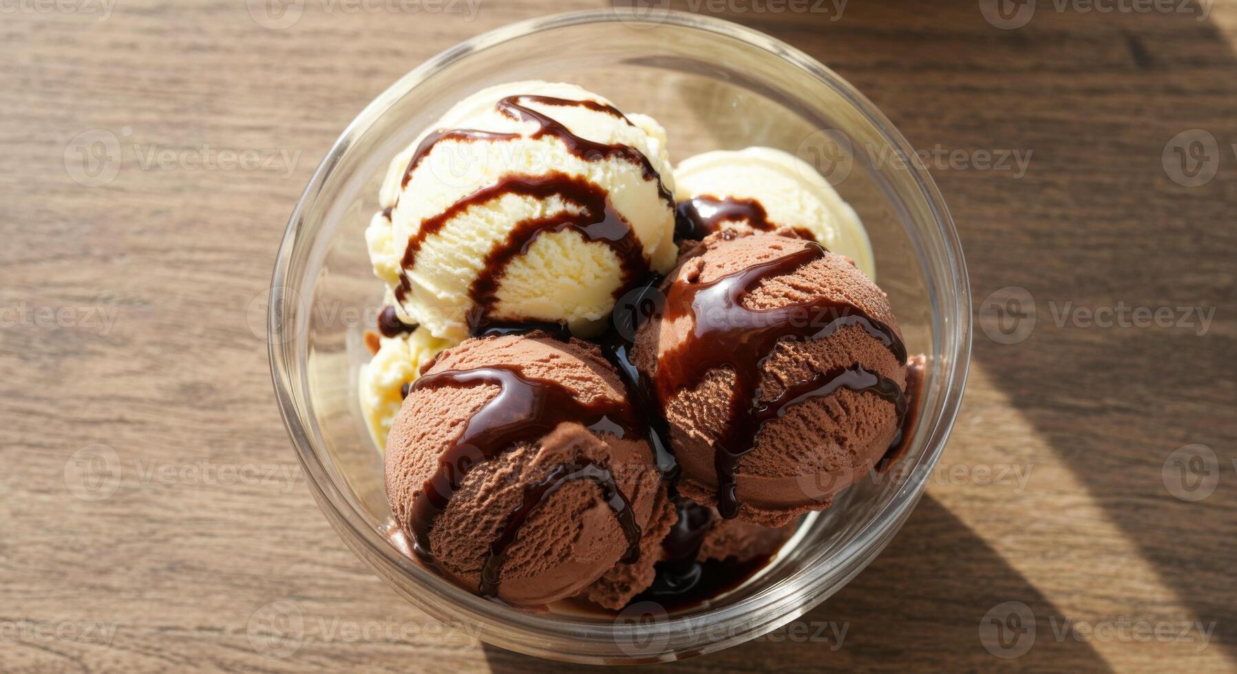 Bowl of Vanilla and Chocolate Ice Cream Scoops with Fudge Drizzle on Wooden Table photo