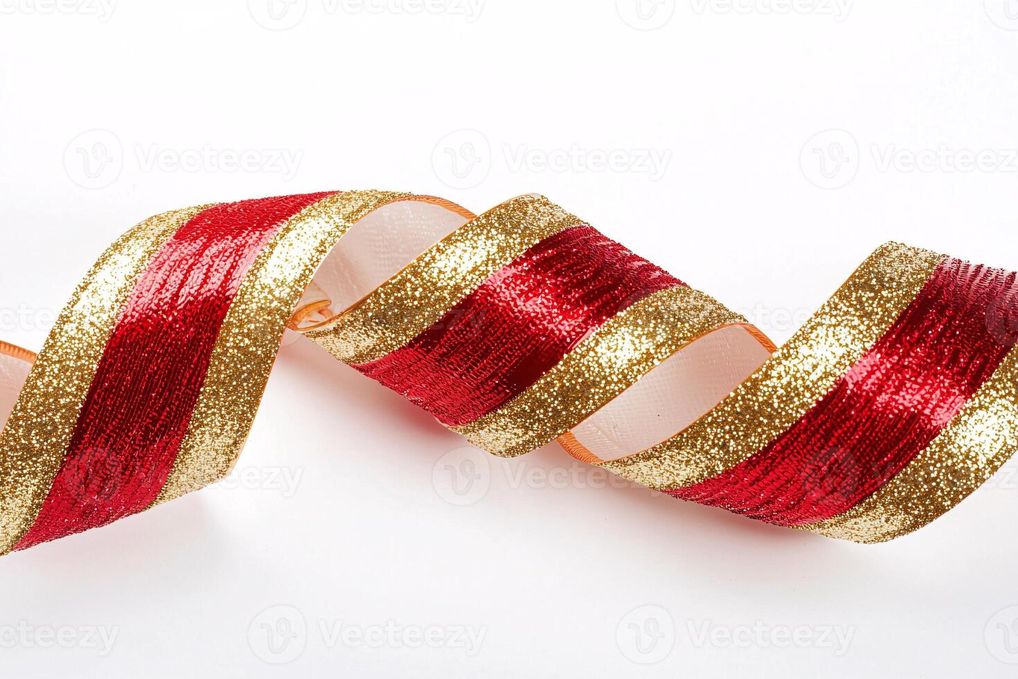 A vibrant red and gold curled ribbon elegantly spirals on a pristine white backdrop, embodying festive charm and sophistication. photo