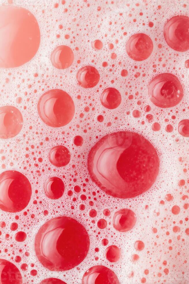 Close-up view of vibrant red bubbles and foam creating a textured surface, showcasing the interplay of light and color in a visually captivating composition photo