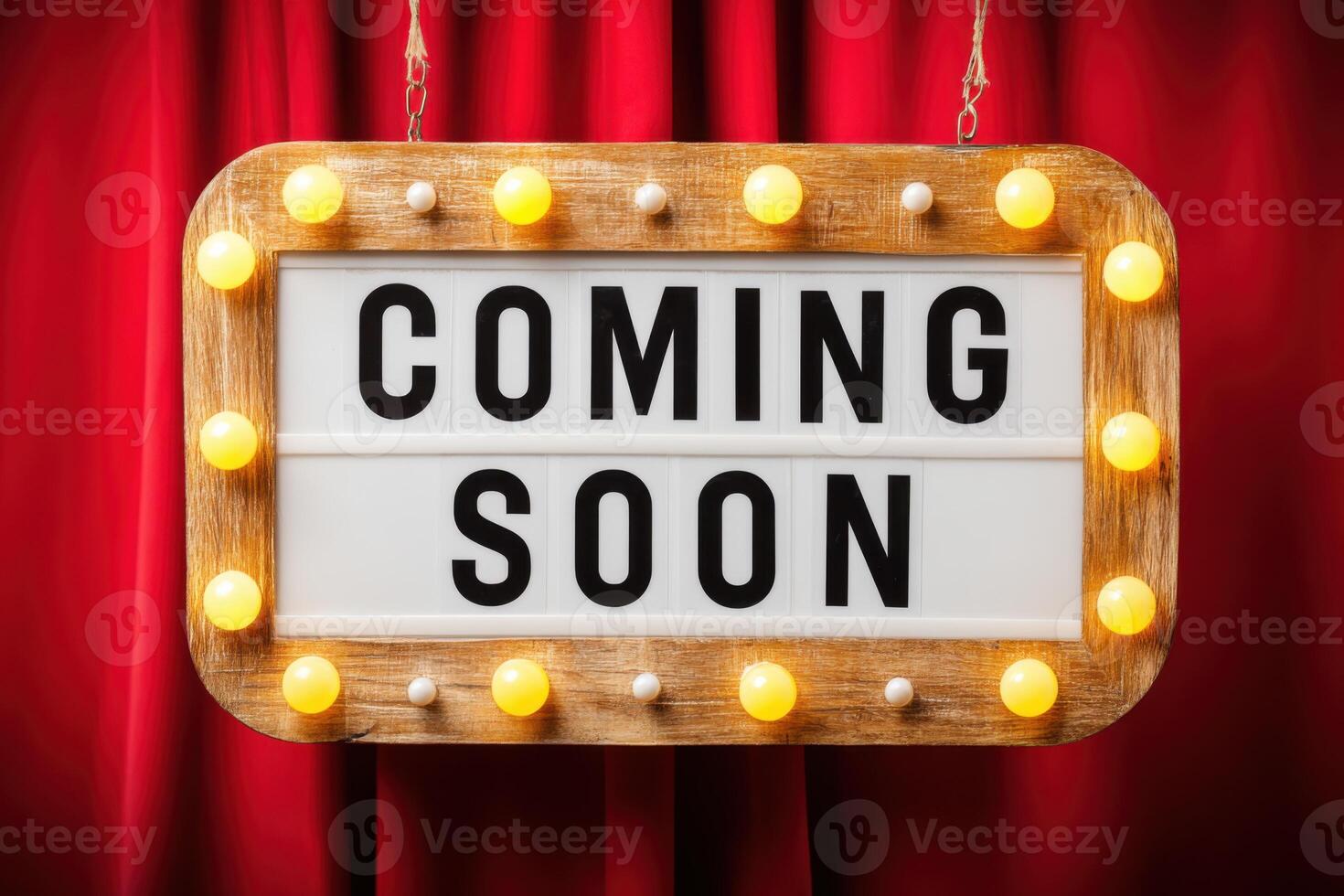 Vintage marquee sign with bright lights displaying the phrase Coming Soon against a rich red curtain backdrop, creating an inviting atmosphere for upcoming events or announcements photo
