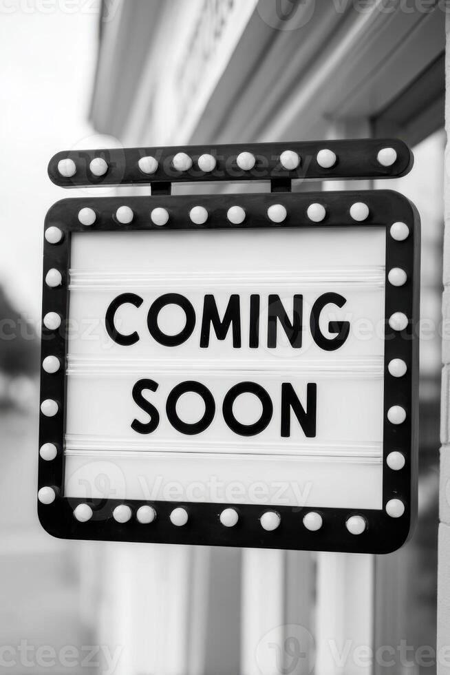 Vintage marquee sign with bright bulbs displaying the phrase Coming Soon, creating an inviting atmosphere for upcoming events or announcements in a stylish setting photo