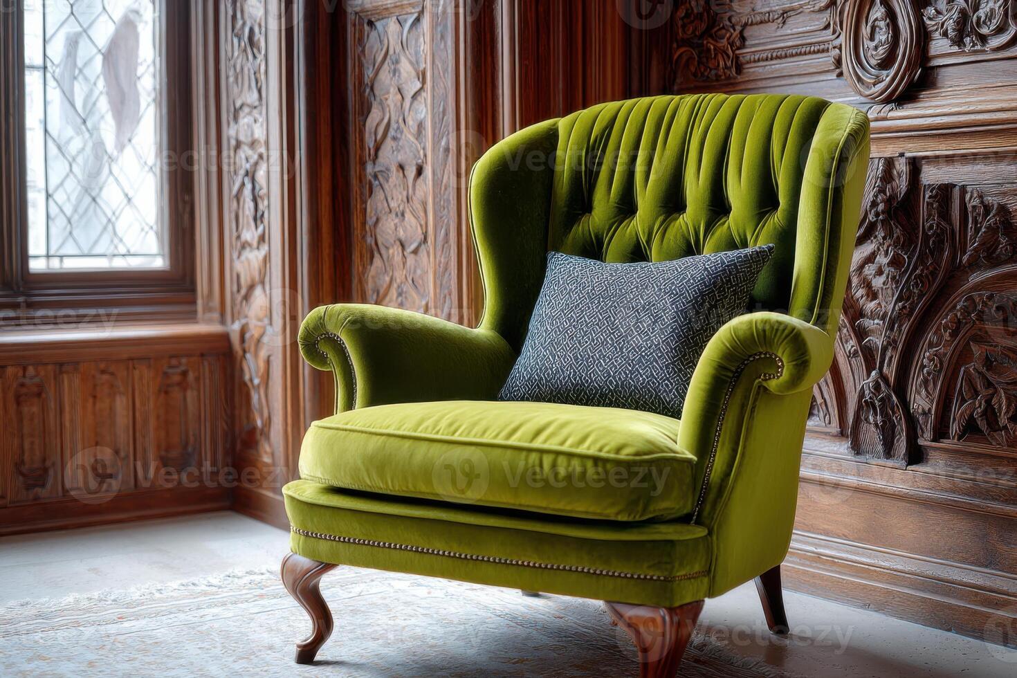 Elegant green velvet armchair with a decorative cushion, positioned in a vintage room featuring ornate wooden paneling and natural light streaming through a stained glass window photo