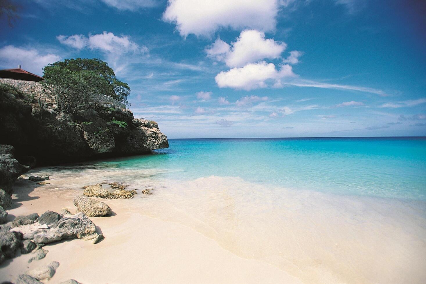 A beach with clear water and white sand photo