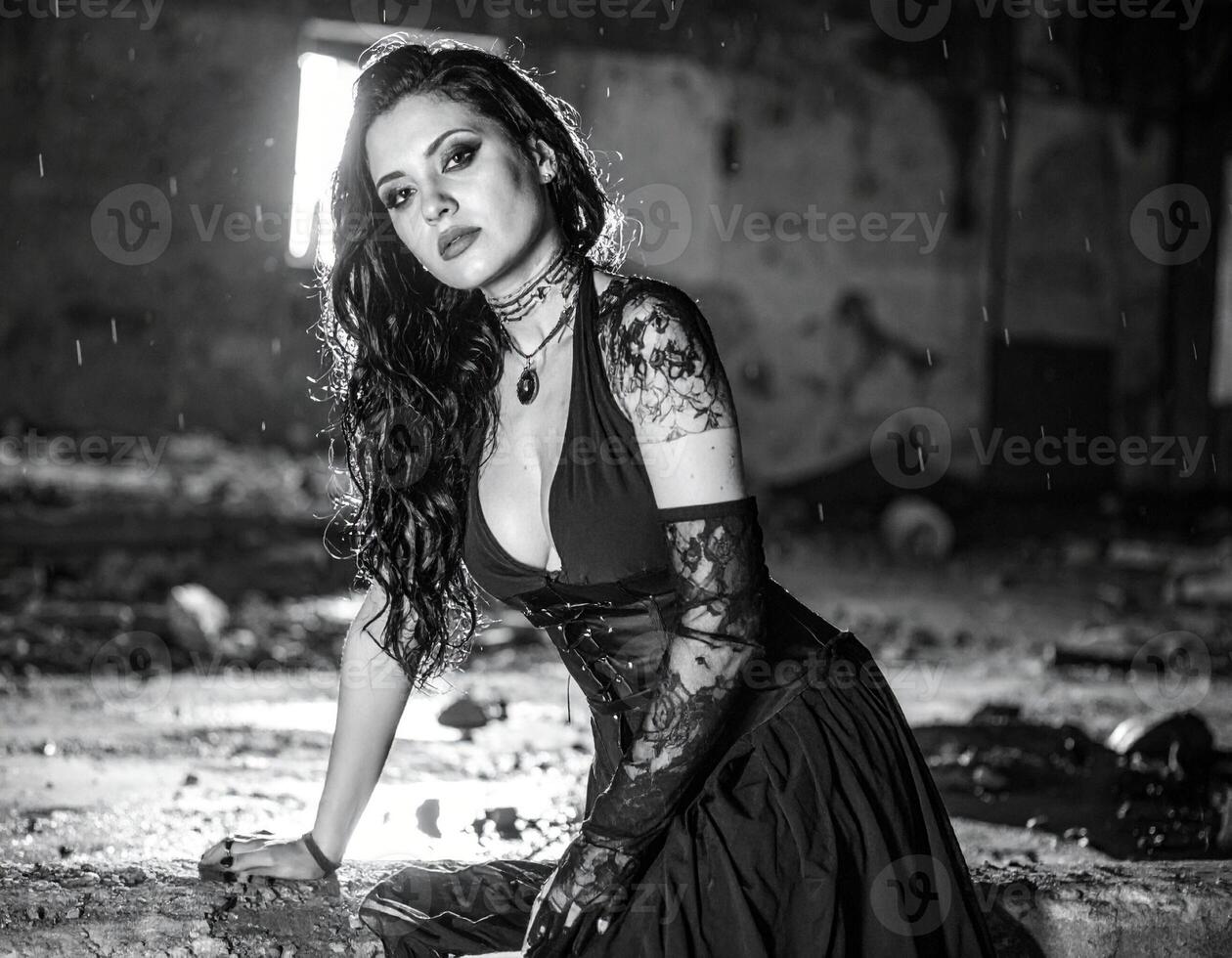 beautiful young goth woman in abandoned factory in bw photo