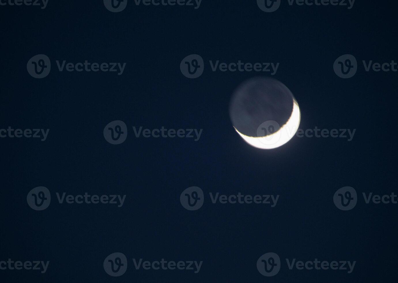 The moon is seen in the dark sky photo