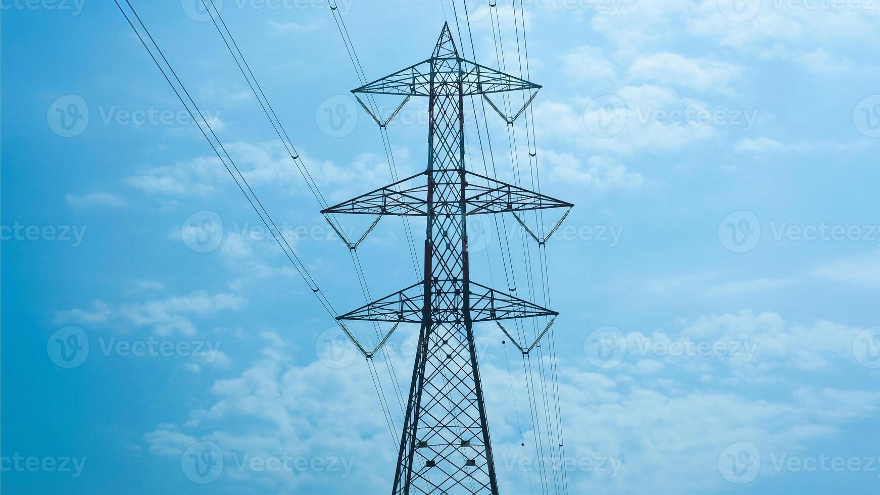 transmission line tower over blue sky photo