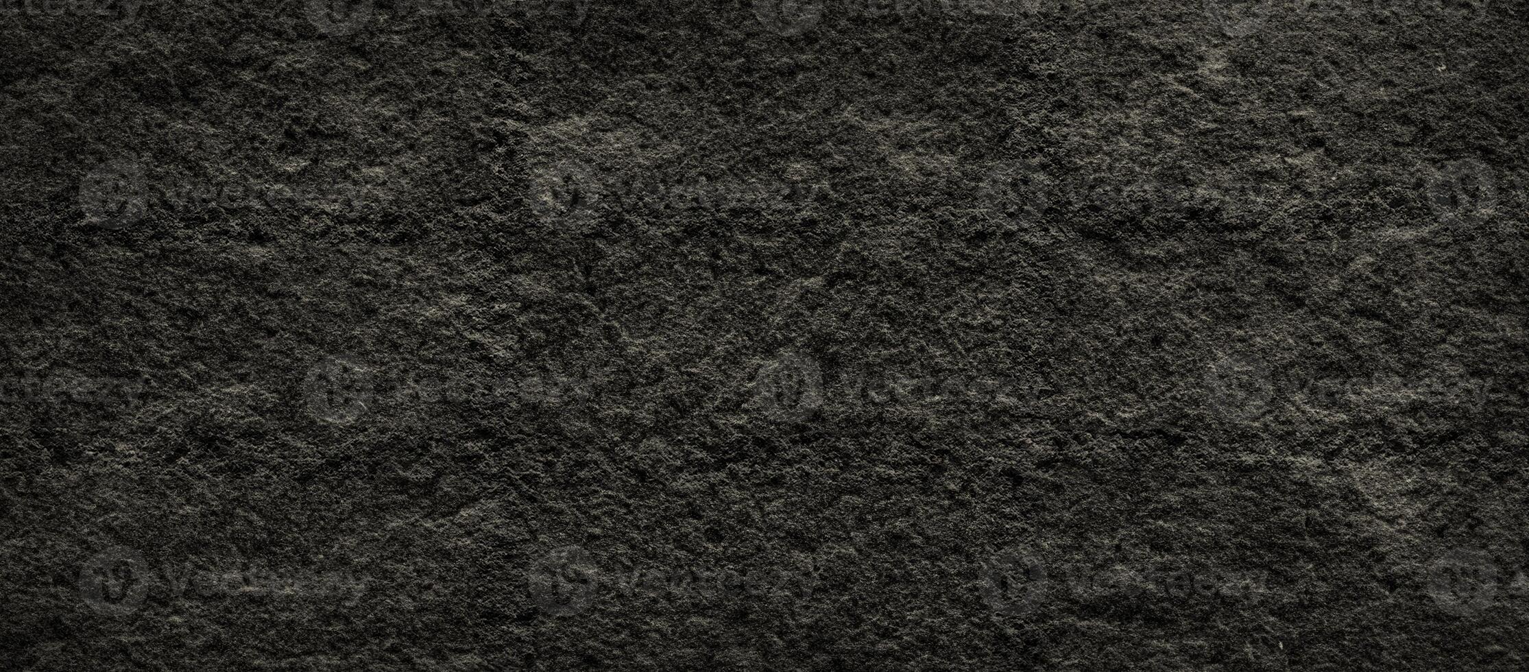 Dark rough stone texture with natural grunge surface look photo