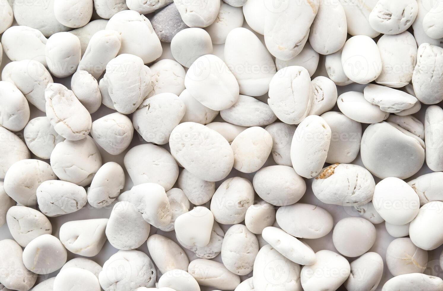 Smooth white pebbles stone texture background in full frame photo