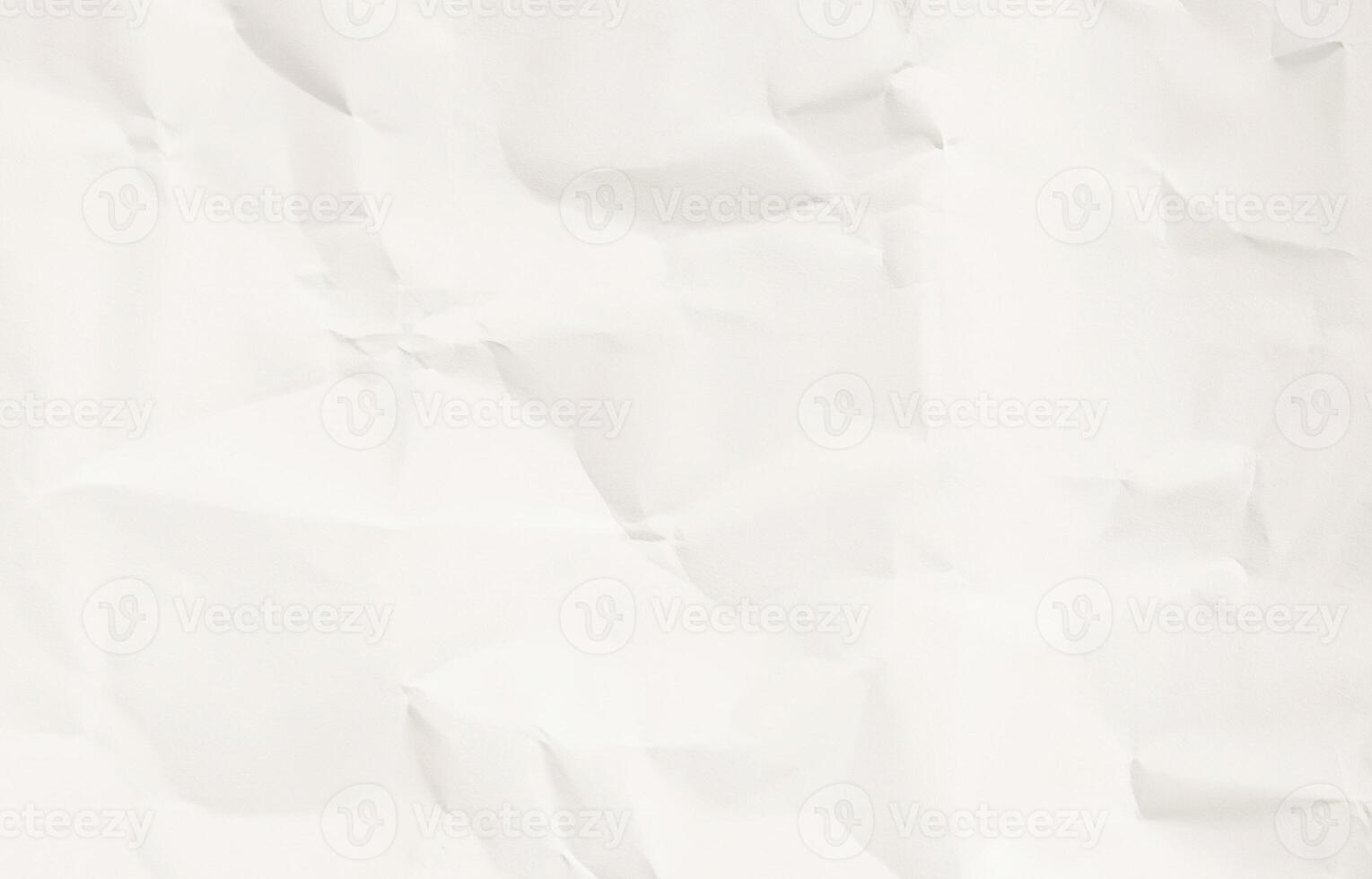 Crumpled white paper texture with soft shadow folds photo