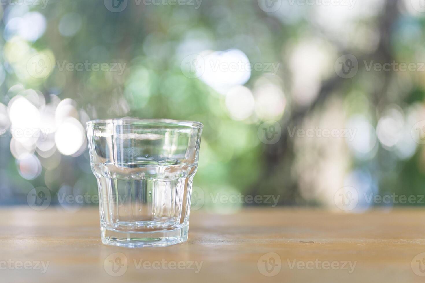 Empty glass of water on table photo