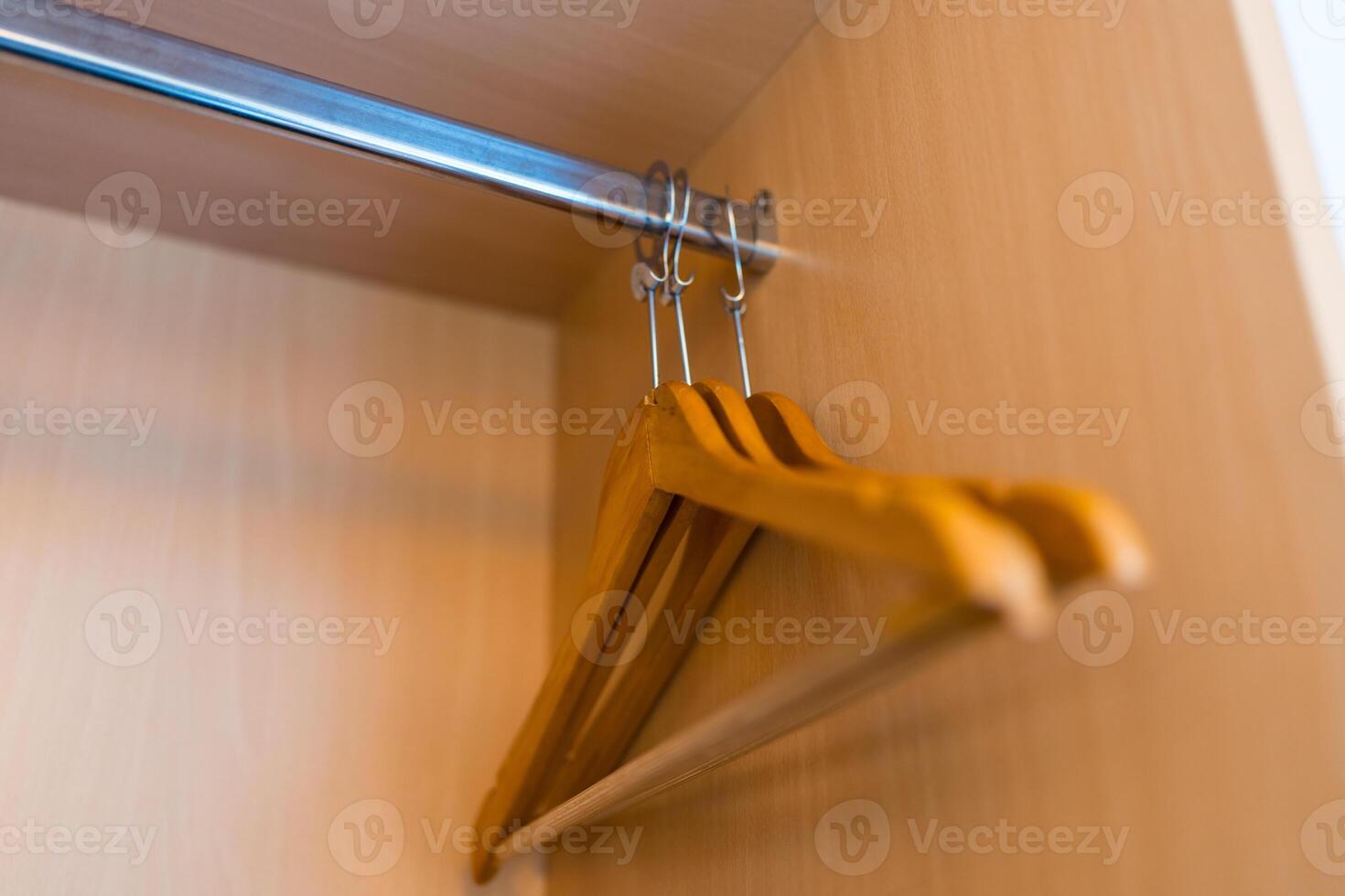 Empty wooden clothes hangers photo