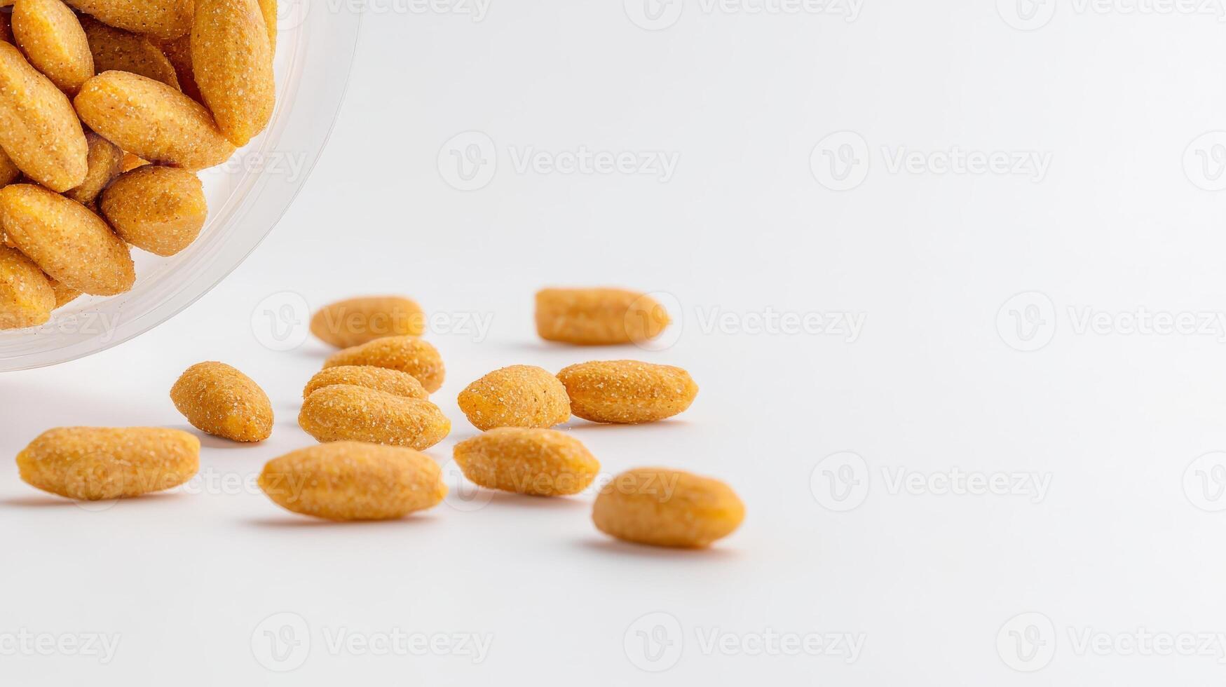 A bowl filled with orange candies on a white surface photo