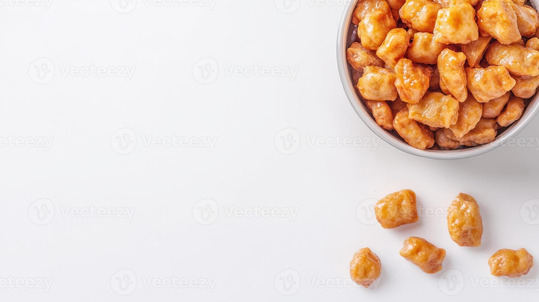 A bowl filled with popcorn and nuts on a white surface photo