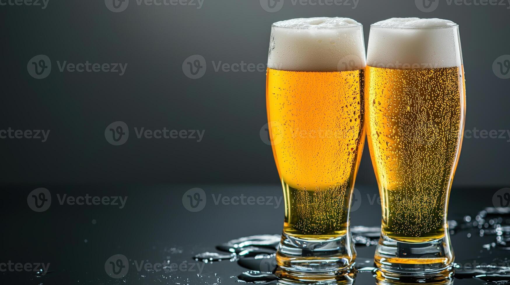 Two glasses of beer with water droplets on a black background photo
