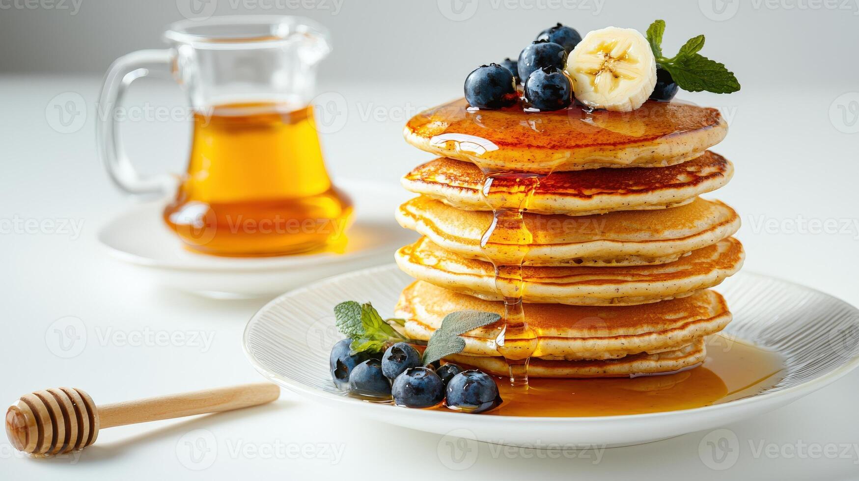 A stack of pancakes with blueberries and syrup photo