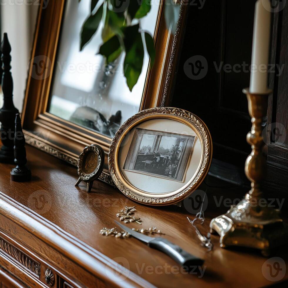 A wooden table with a mirror, a picture frame and a candle photo