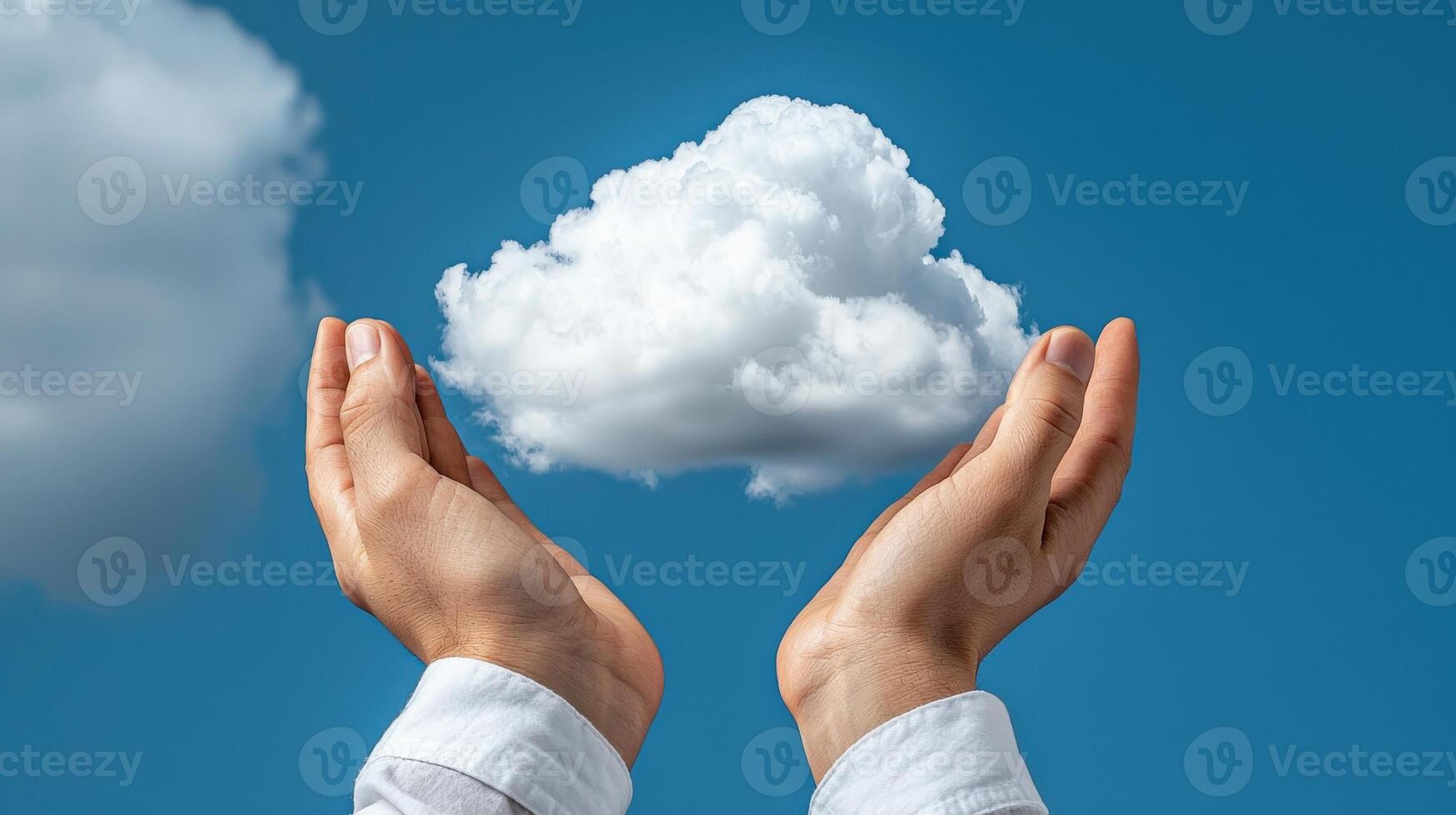 Hands holding up a cloud in front of a blue sky photo