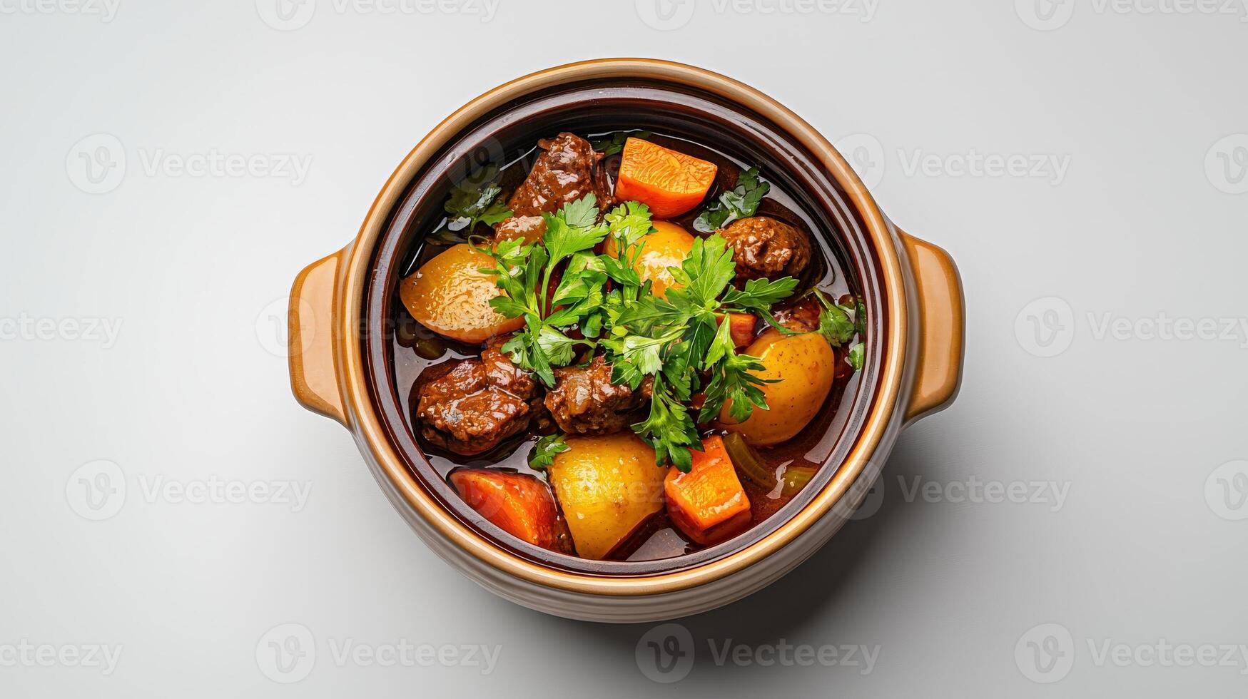 A brown pot filled with stew and vegetables photo