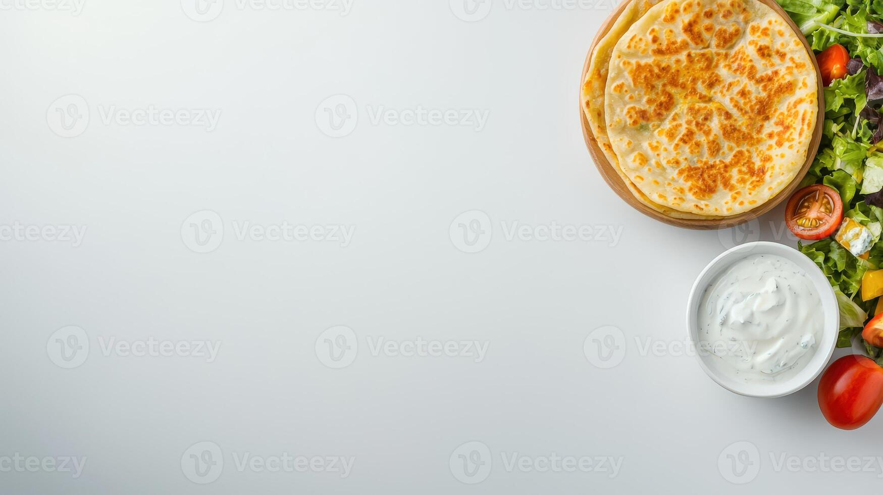 Turkish quesadilla with cheese, tomatoes, lettuce and cucumber on white background top photo