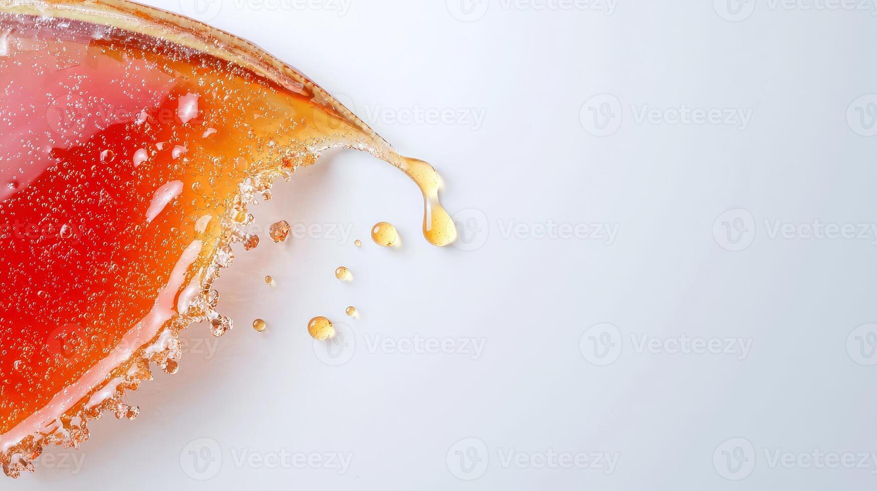 A piece of orange juice being poured into a glass photo