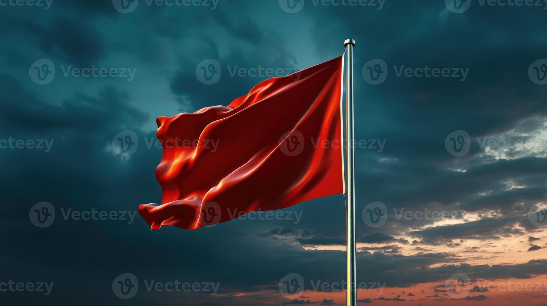 Red flag waving in the wind against a cloudy sky photo