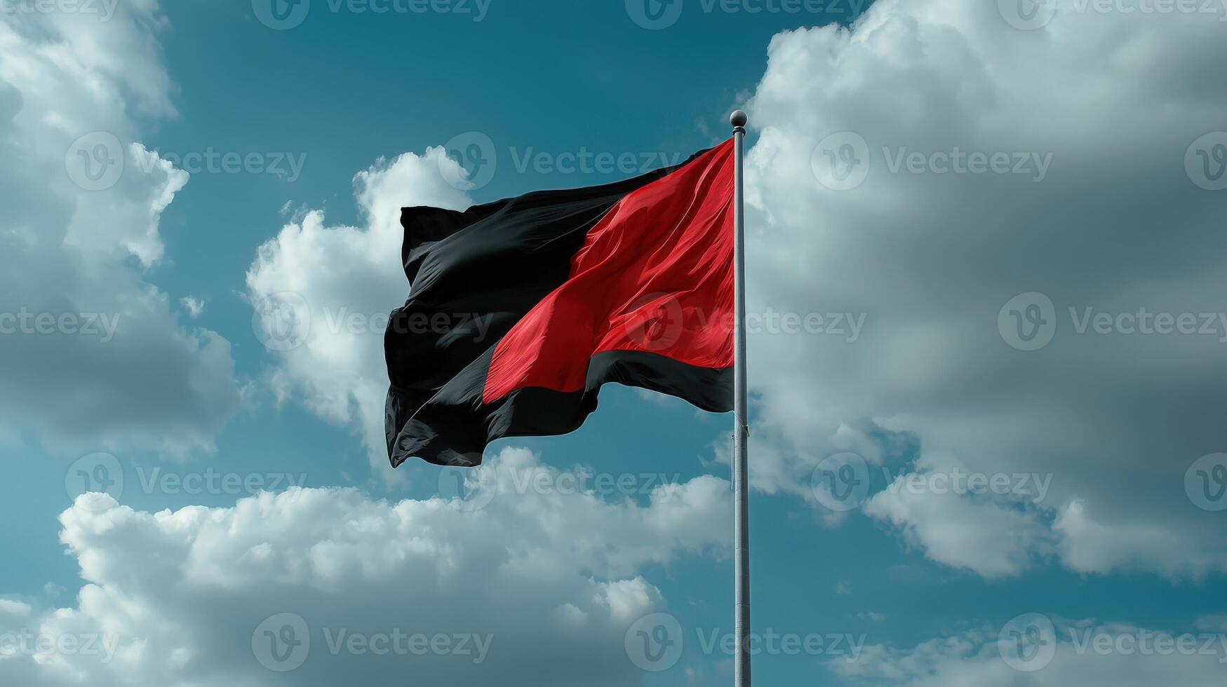 A red and black flag flying in the wind photo