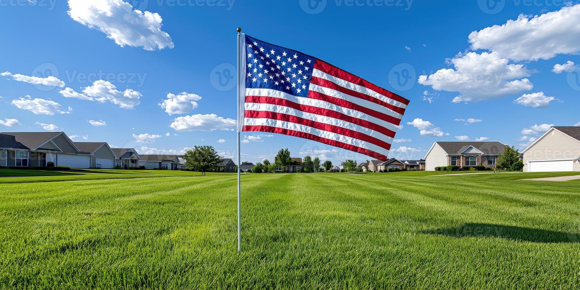 A large american flag in a field of grass photo