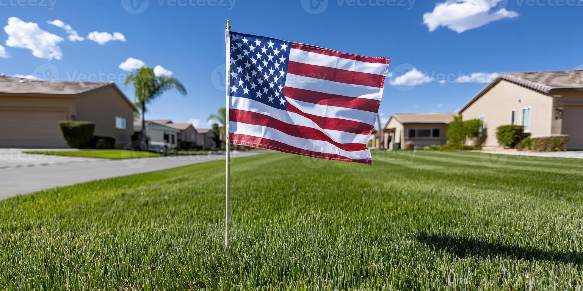 A flag in the grass in front of a house photo