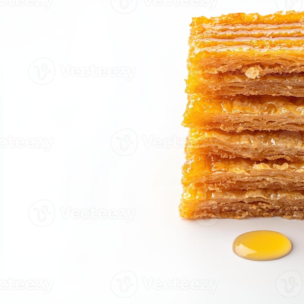 A stack of honeycomb with a drop of honey photo