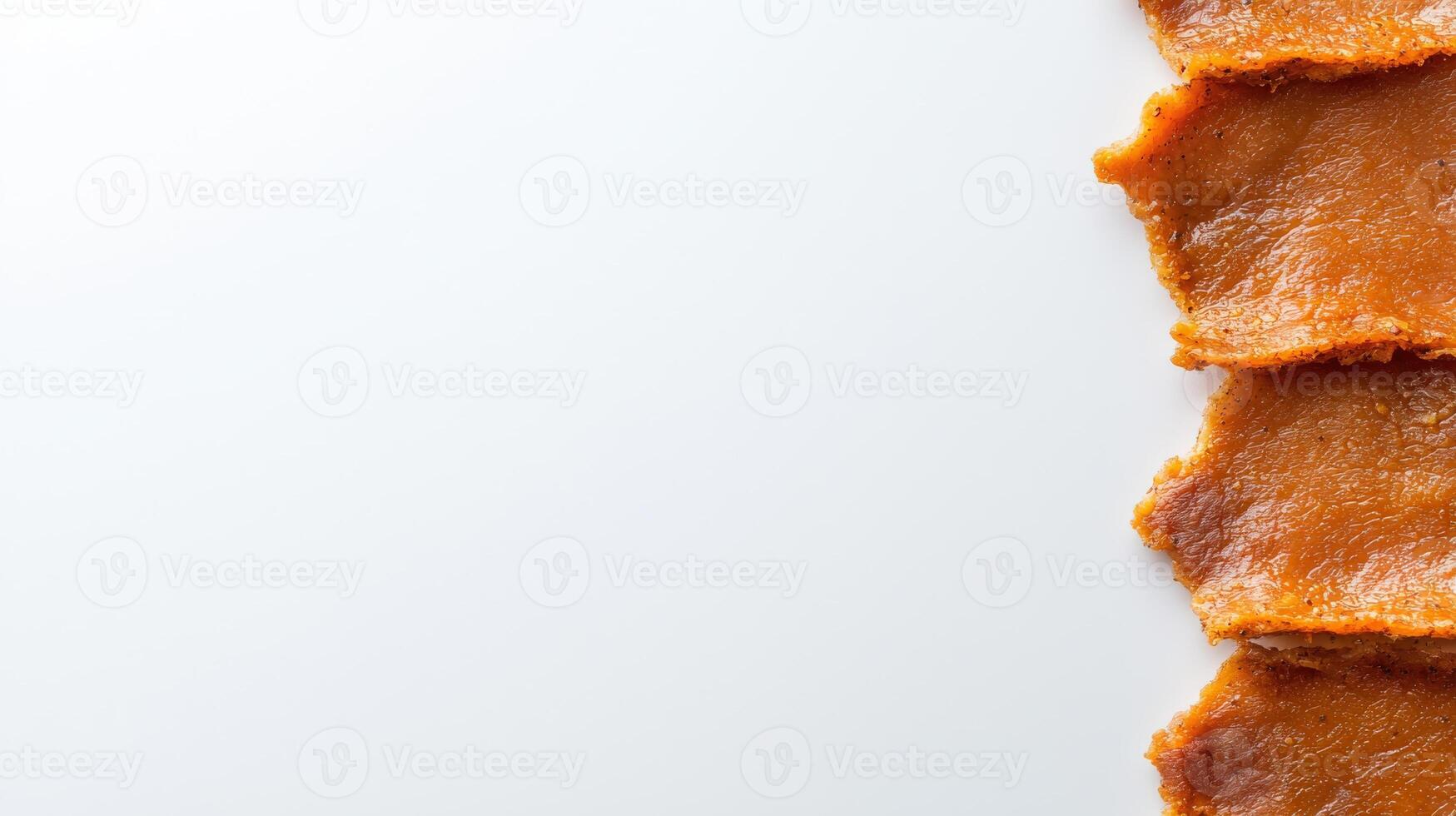 A piece of bacon on a white surface photo