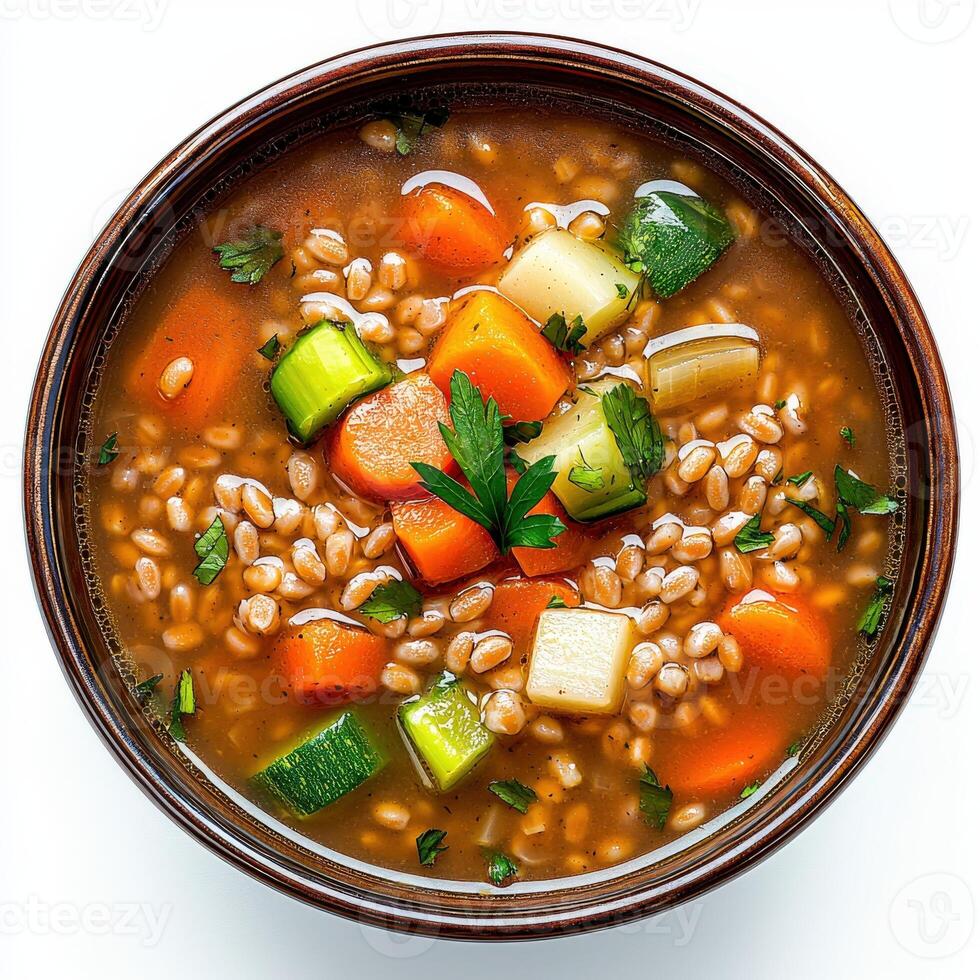 A bowl of vegetable soup with carrots, celery and parsley photo