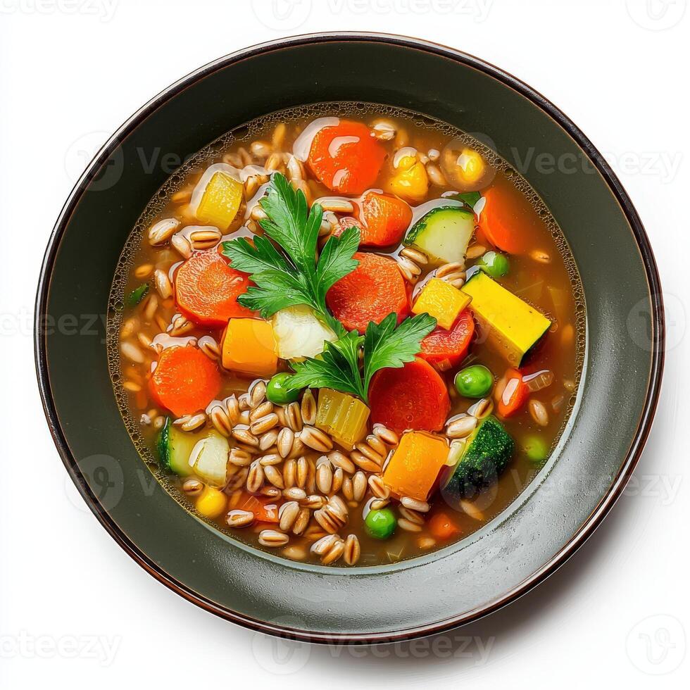 A bowl of vegetable and barley soup with a green leaf photo