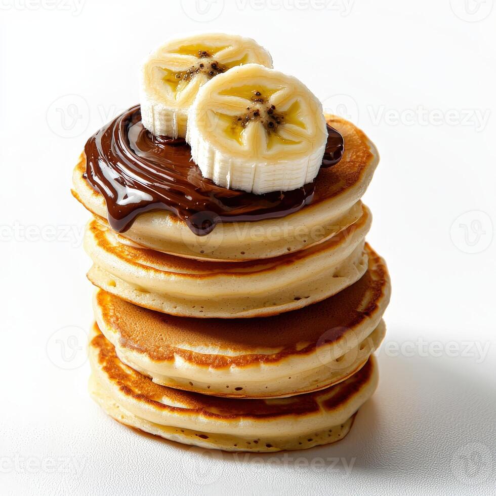 A stack of pancakes topped with chocolate and bananas photo