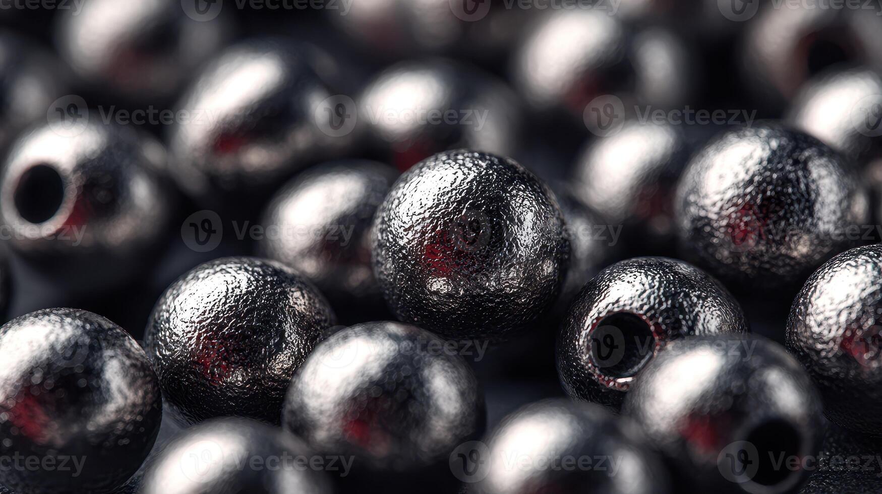 Close-up view of shiny metallic beads arranged on a dark surface showcasing texture and reflections photo