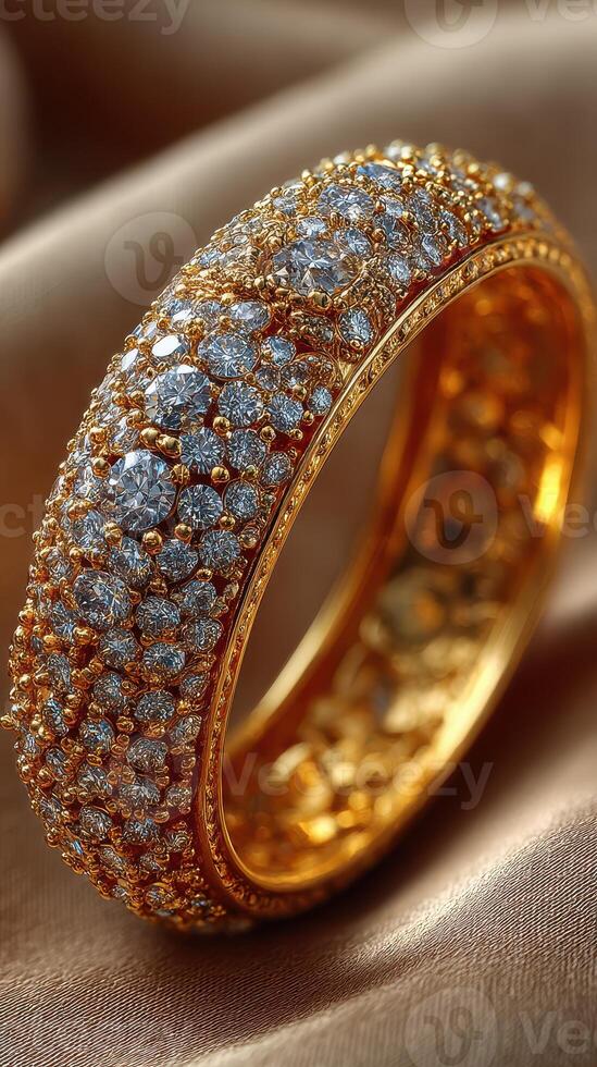 Sparkling golden ring adorned with numerous diamonds rests elegantly on soft fabric photo