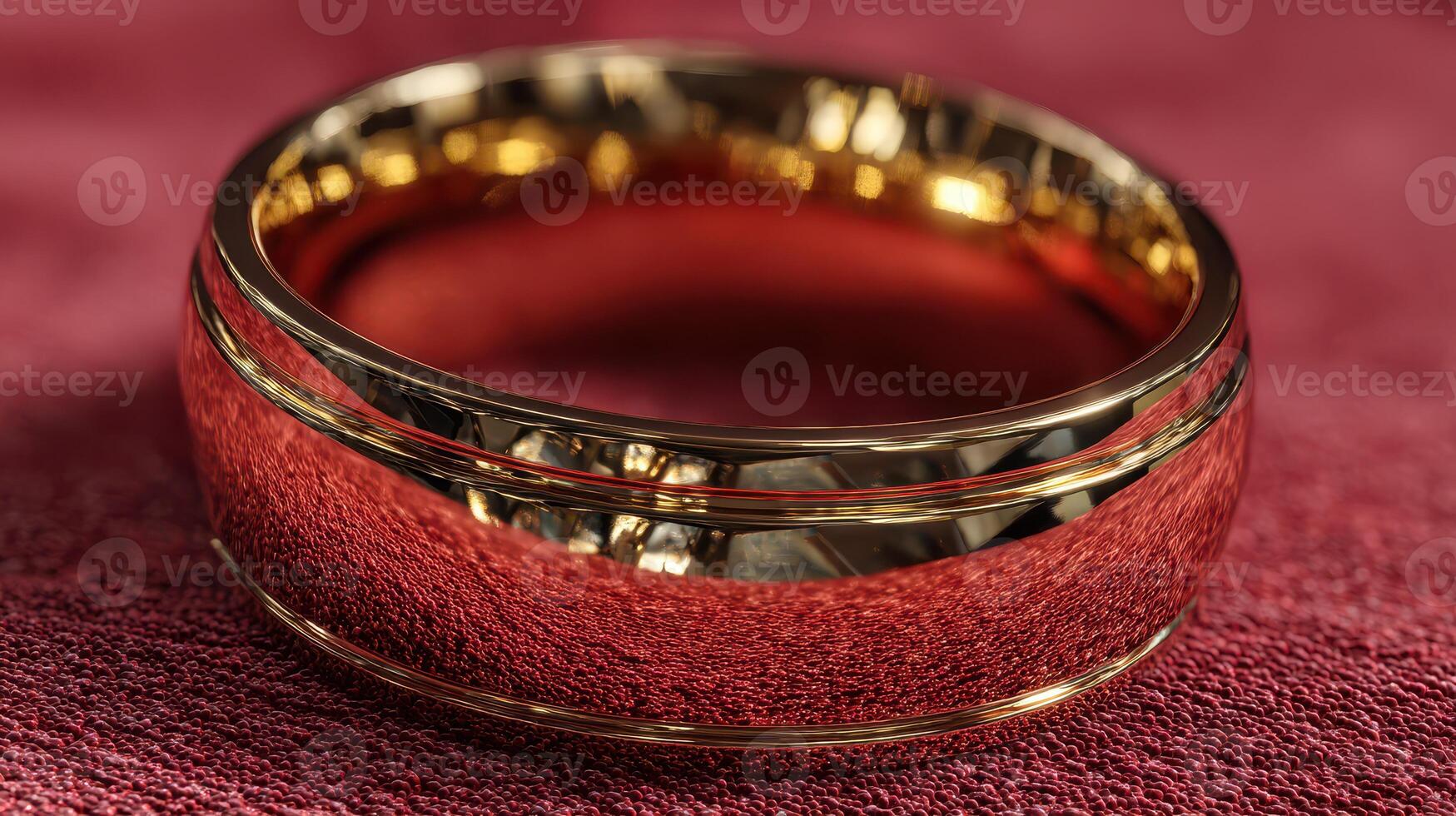 Elegant gold ring reflecting light on a rich red fabric background, showcasing its detailed craftsmanship and shiny finish photo