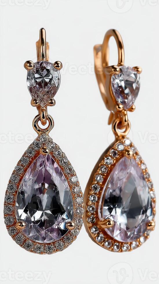 Elegant tear-shaped earrings featuring sparkling gemstones and intricate detailing in a gold setting photo