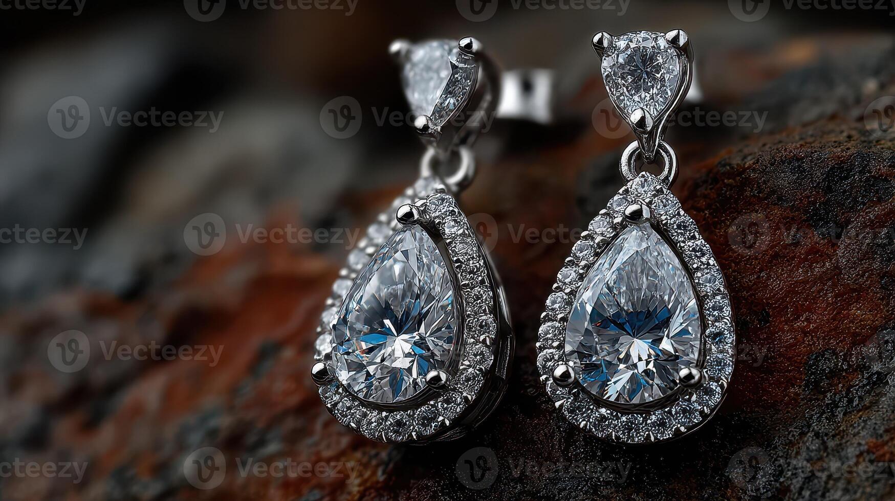 Elegant diamond earrings displayed on a textured surface highlighting their intricate design and brilliance during daylight photo