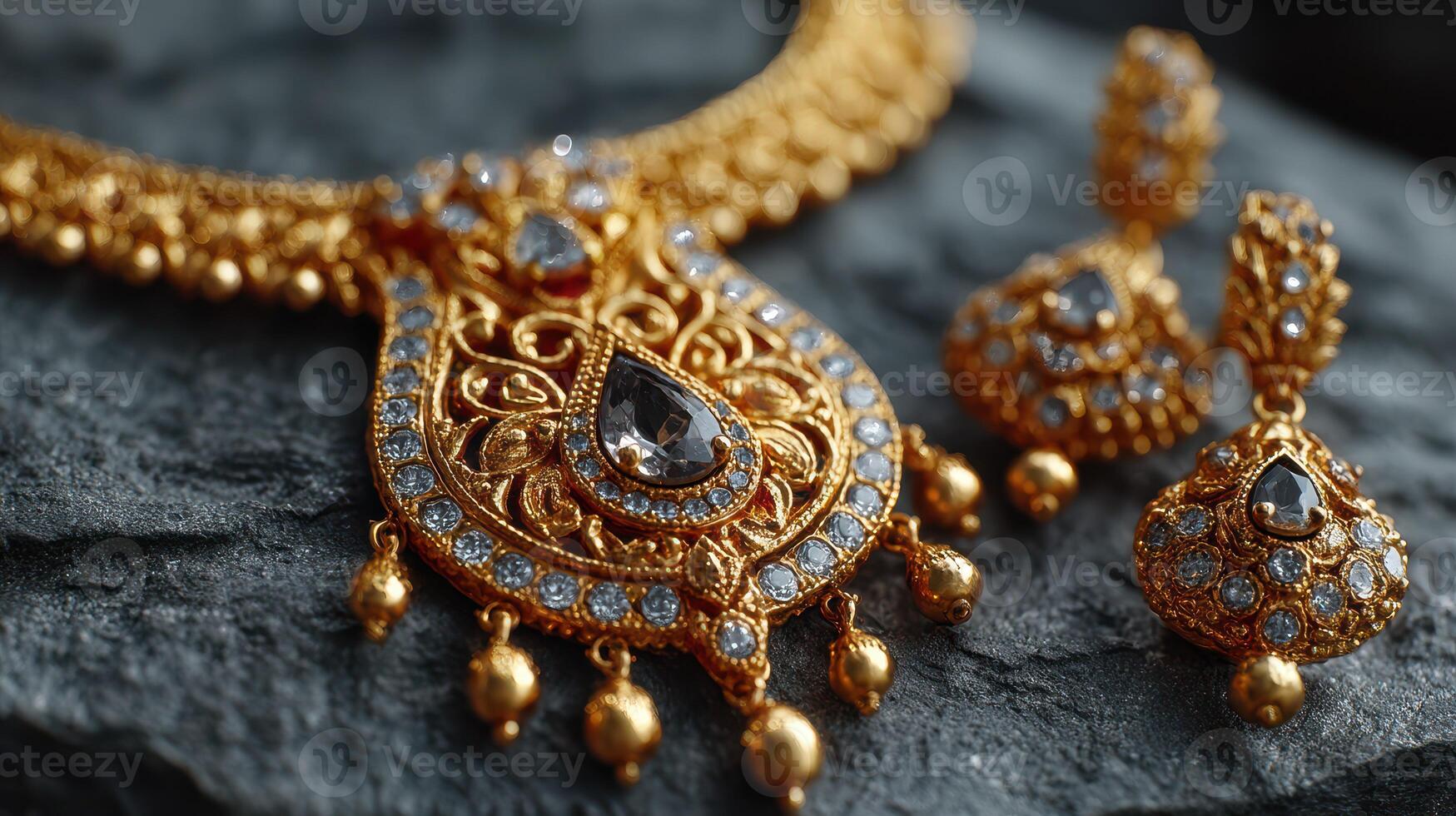 Ornate gold jewelry displayed on dark textured surface showcasing intricate design and sparkling gemstones photo