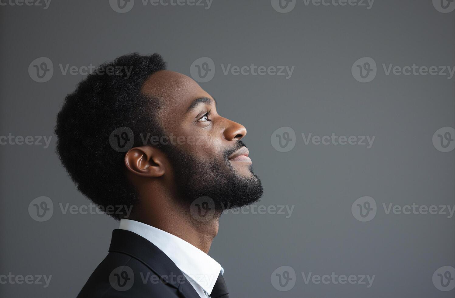 A man in a suit and tie is looking up at the sky photo