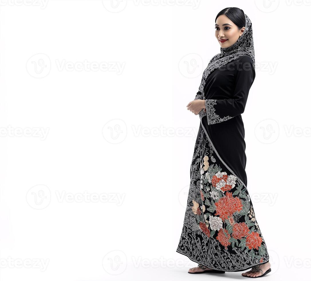 The dress is long and flowing, and the woman is smiling photo
