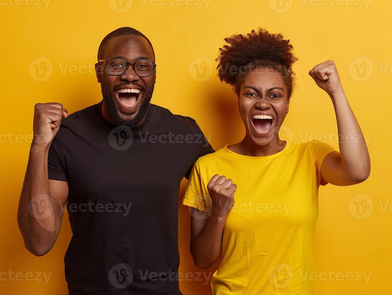 A man and woman are smiling and raising their hands in the air photo