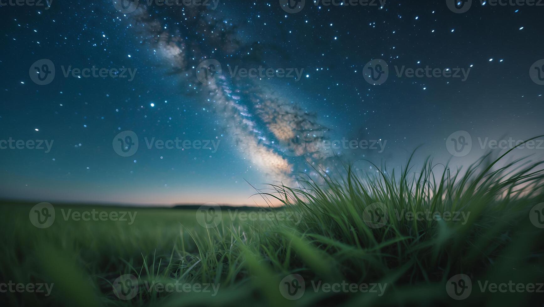Milky Way Glowing Over Green Field at Night with Stars photo