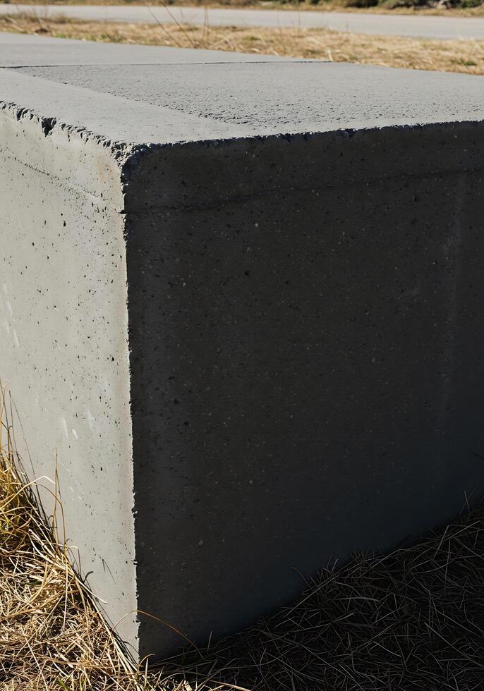 A concrete block sitting in the grass photo