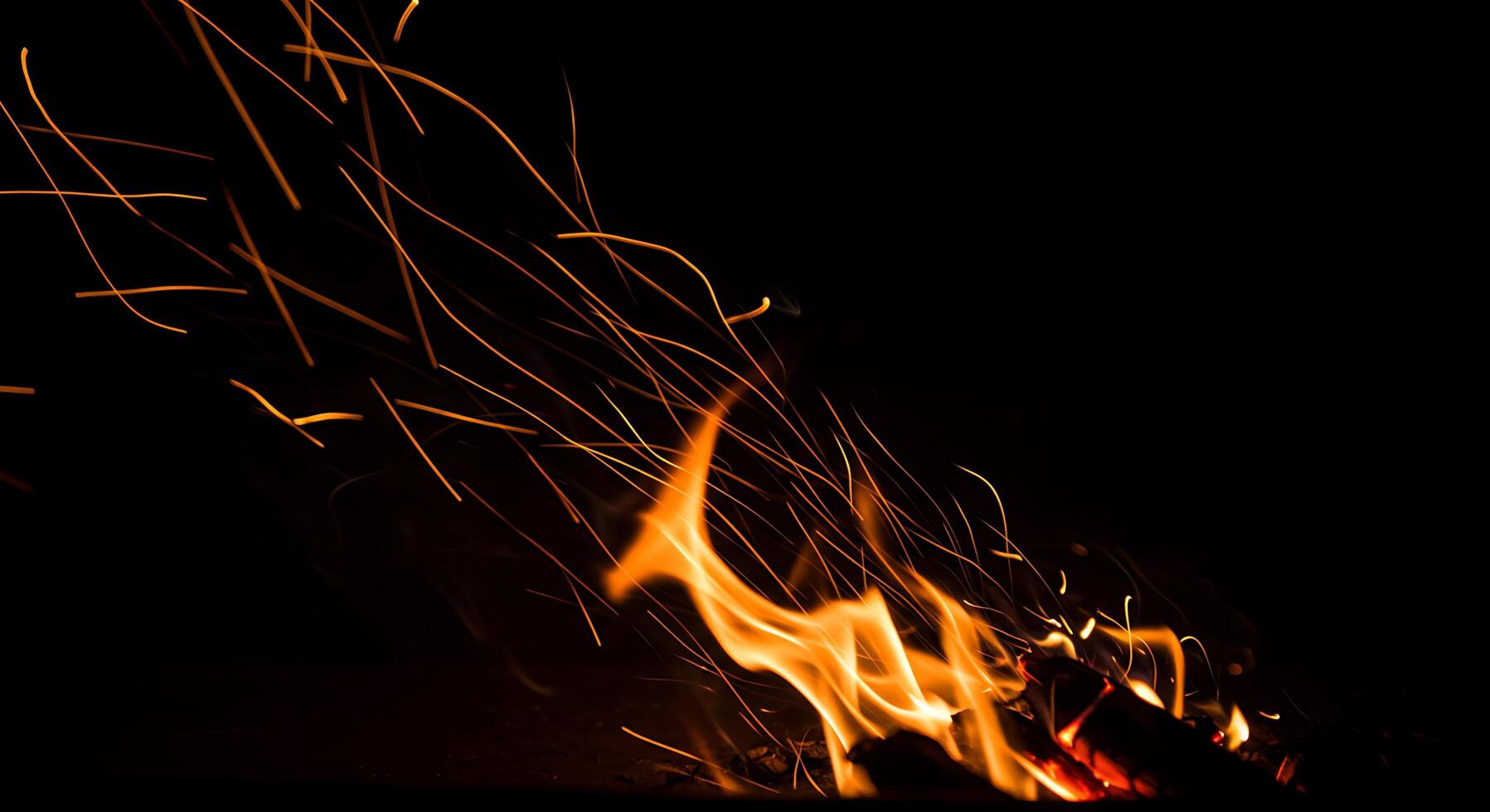 A fire is burning in the dark photo